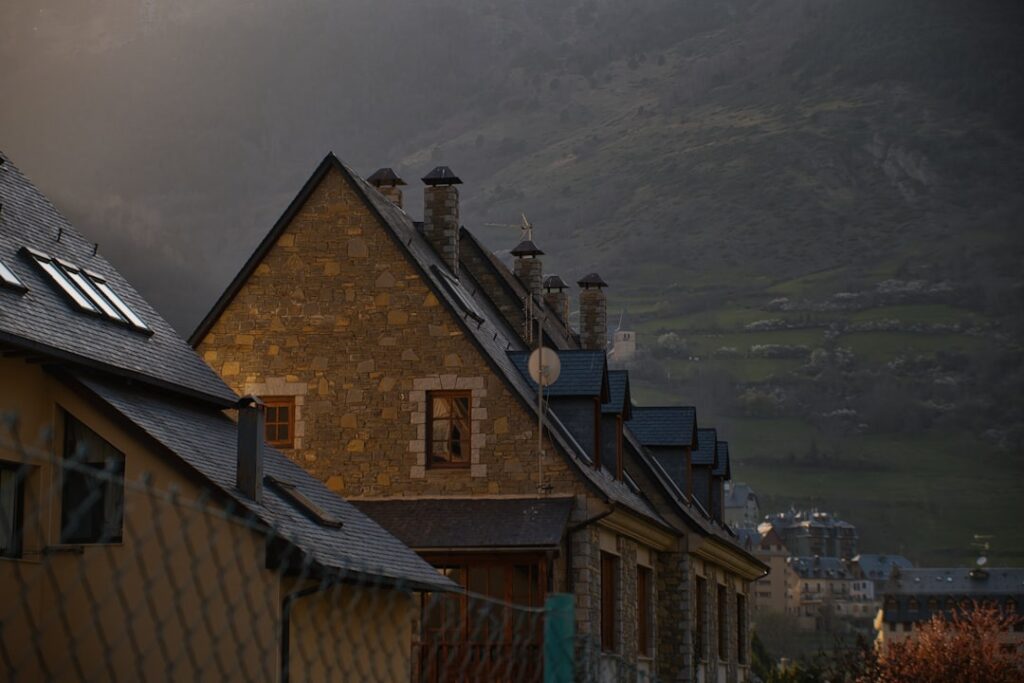 brown brick building near mountain during daytime